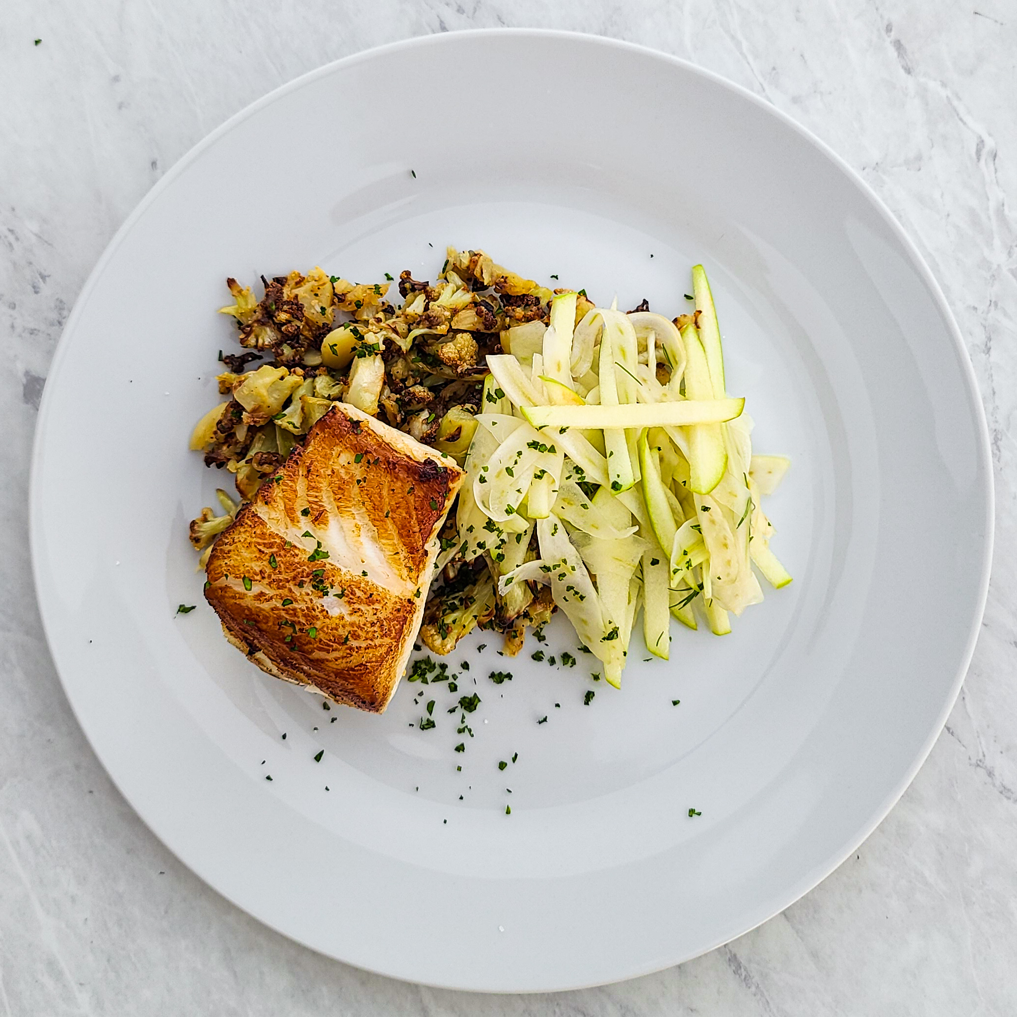 Pan Seared Chilean Sea Bass with Roasted Garlic Cauliflower & Fennel Apple Salad with Apple Cider Hemp Seed Vinaigrette