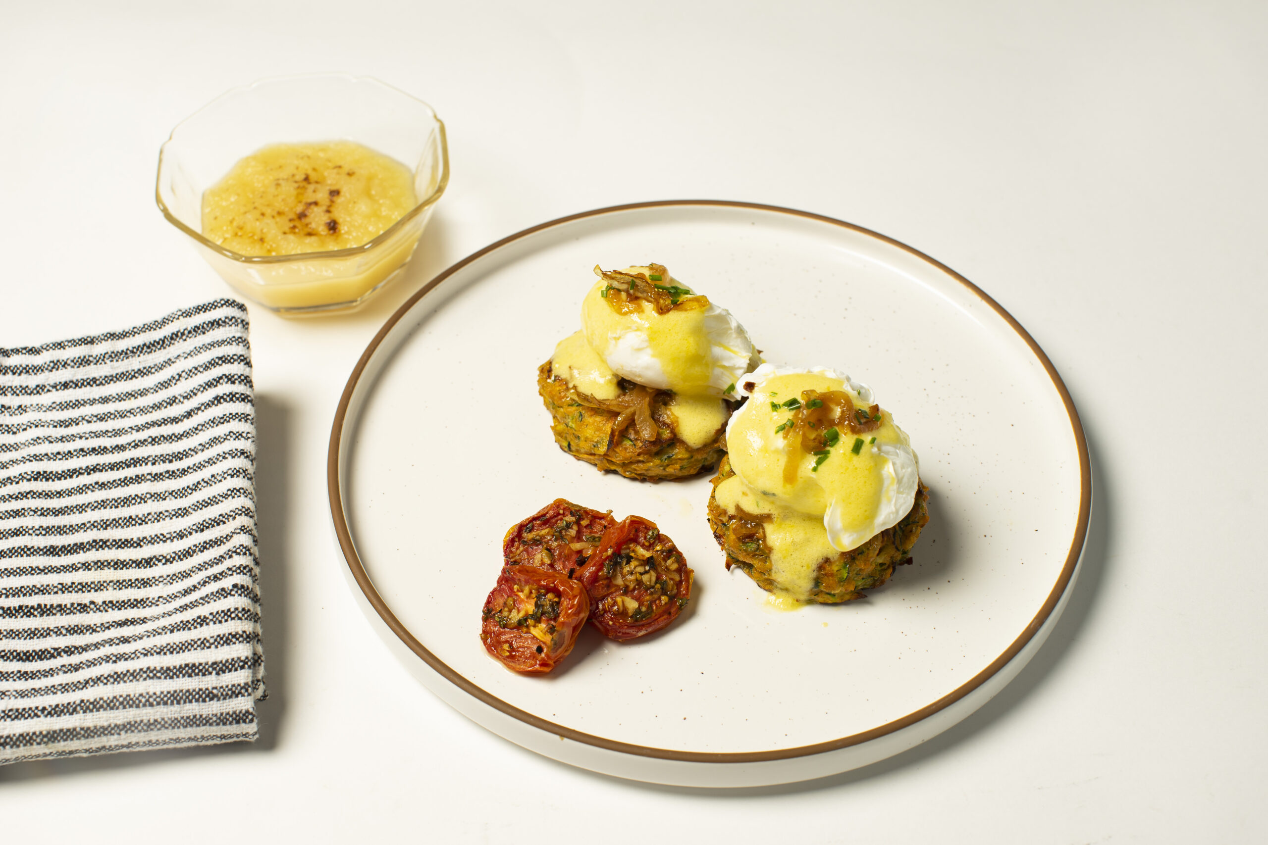 Zucchini & Yam Fritter Benedict with Foamed Hollandaise, Caramelized Onions, Roasted Roma Tomatoes, Applesauce