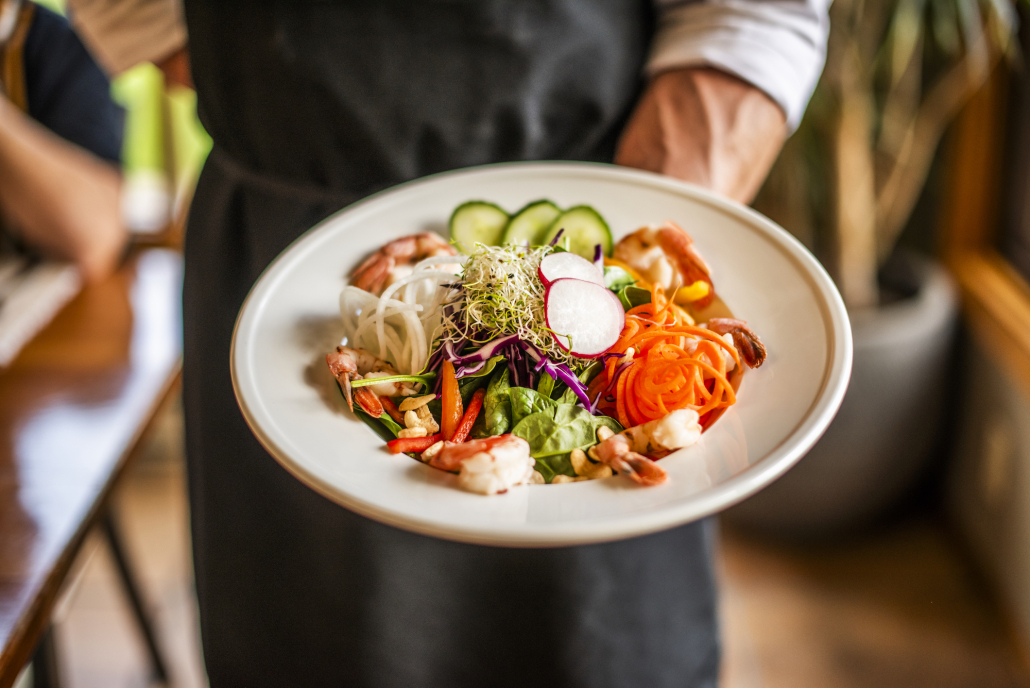 healthy plate of food being served by a chef