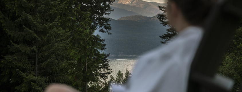 Guest in Robe Relaxing at Mountain Trek Health Reset Retreat overlooking Mountains and lake