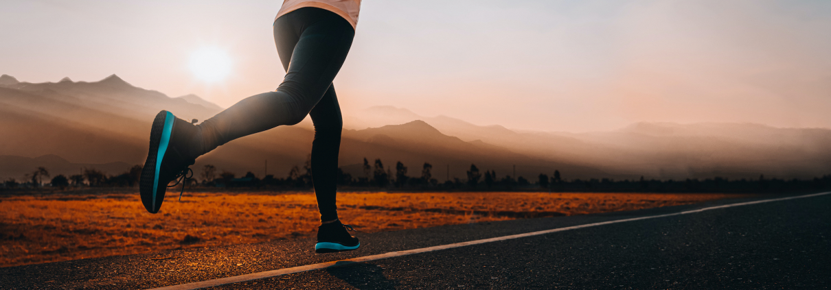 woman running outside with beautiful summer evening in the mountains